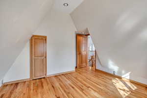 Additional living space featuring light wood-type flooring, lofted ceiling, and recessed lighting