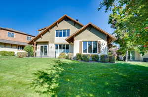 Rear view of property featuring a lawn