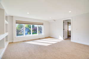 Unfurnished room with light carpet and recessed lighting