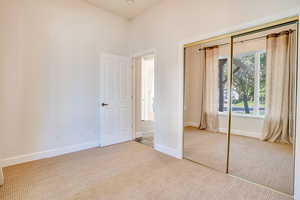 Unfurnished bedroom featuring carpet floors and a closet