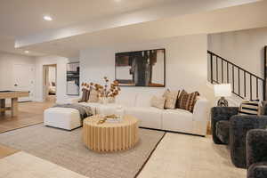 Living area featuring recessed lighting, light wood-style flooring, and stairway