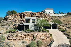 Contemporary house featuring stucco siding and driveway