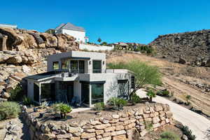 Back of property featuring stucco siding and a sunroom