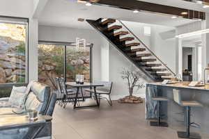 Dining room with stairs, light tile patterned floors, recessed lighting, and beam ceiling