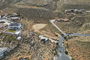Aerial view of property and surrounding area featuring nearby suburban area