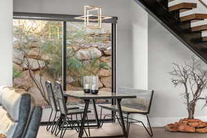 Dining area featuring stairs and baseboards