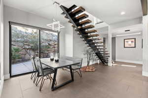Dining area with baseboards and stairway