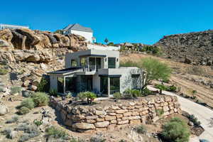Back of property featuring stucco siding, a patio, and a balcony