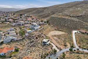 Aerial view of property's location with a mountainous background and nearby suburban area