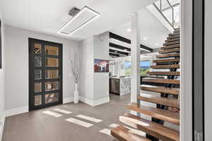 Stairway featuring recessed lighting and tile patterned floors
