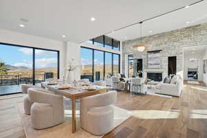 Dining area featuring recessed lighting, light wood finished floors, a fireplace, and a mountain view