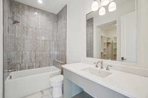 Bathroom featuring shower / bath combination, vanity, a chandelier, light marble finish floors, and a closet