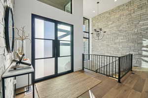 Foyer entrance with wood finished floors and baseboards