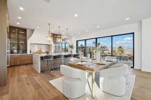 Dining area with recessed lighting, light wood-style floors, and a mountain view