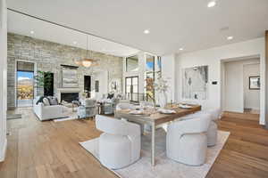 Dining area featuring recessed lighting, light wood finished floors, and a large fireplace