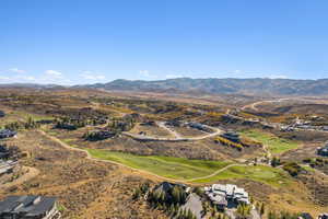 View of property location featuring a mountainous background and a golf course