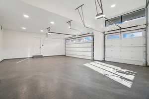 Garage featuring recessed lighting and a garage door opener