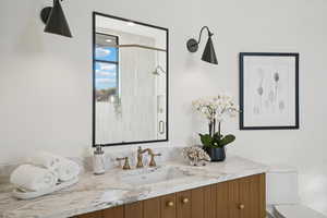 Full bath featuring vanity and a stall shower