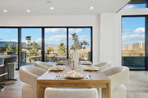 Dining room featuring light wood-style floors, recessed lighting, and a mountain view