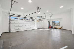 Garage featuring recessed lighting and a garage door opener