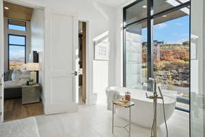Doorway with tile patterned floors and recessed lighting