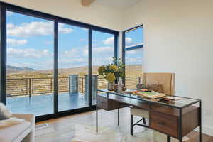 Office area featuring light wood-style floors and a mountain view