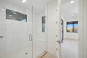 Full bathroom featuring a shower stall, light carpet, and recessed lighting