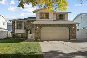 View of front of home with brick siding, driveway, an attached garage, and a shingled roof
