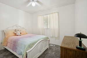 Bedroom featuring dark colored carpet and ceiling fan