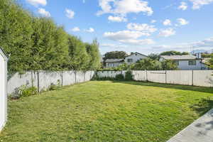 Fenced backyard featuring a residential view