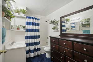 Bathroom featuring shower / tub combo with curtain and vanity