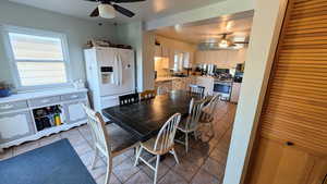Dining room featuring light tile patterned floors and a ceiling fan