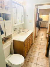 Bathroom with vanity and light tile patterned flooring