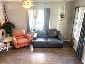 Living area with wood finished floors and ceiling fan