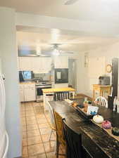 Dining area with light tile patterned floors