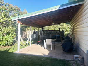 View of patio / terrace with ceiling fan and area for grilling