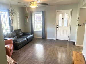 Living area featuring wood finished floors and ceiling fan