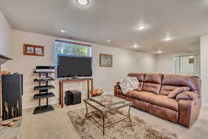 Living room with light carpet and recessed lighting