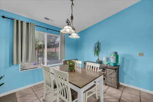 Dining area with light tile patterned floors