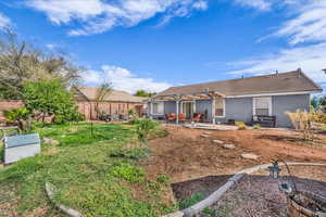 Rear view of property featuring a patio, a pergola, stucco siding, and a tiled roof