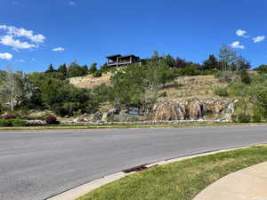 View of asphalt street featuring curbs and sidewalks