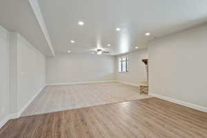 Basement with recessed lighting, light wood-style floors, and ceiling fan