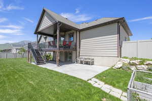 Back of house with a patio area, a shingled roof, a deck with mountain view, and stairway