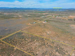 Aerial view of sparsely populated area featuring mountains and property boundaries highlighted