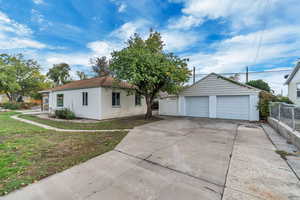 Ranch-style house with a detached garage and an outdoor structure