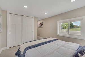 Bedroom with carpet flooring, recessed lighting, and a closet
