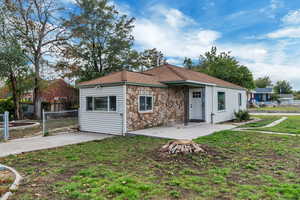 View of front of house featuring a patio area and stone siding