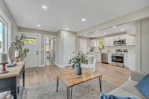 Living area featuring light wood-style flooring and recessed lighting