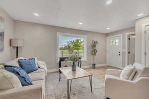 Living room featuring wood finished floors and recessed lighting