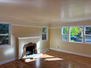 Unfurnished living room featuring a fireplace and wood finished floors